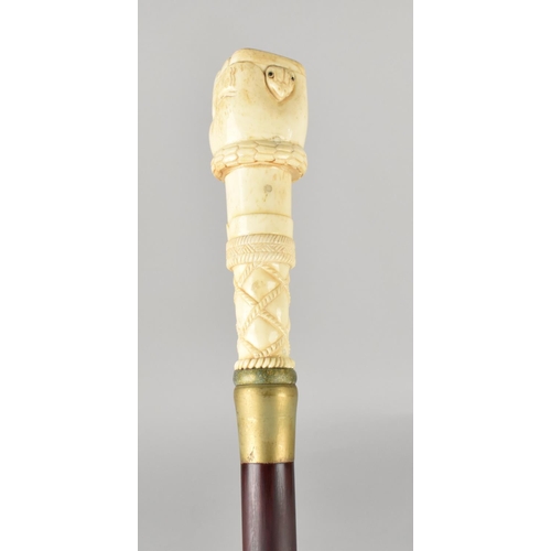 96 - A Bone Effect Handled Walking Stick in the Form of a Clenched Fist Holding Serpent, 97.5cms Long