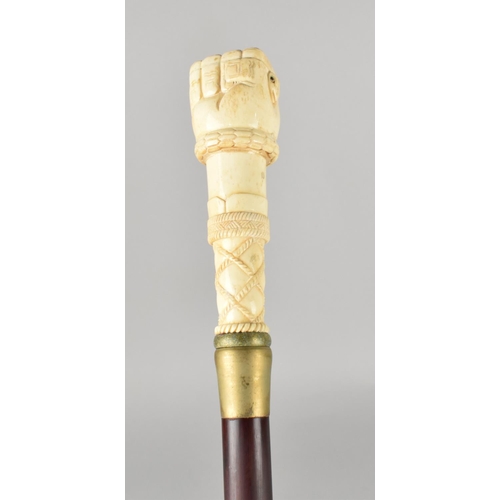 96 - A Bone Effect Handled Walking Stick in the Form of a Clenched Fist Holding Serpent, 97.5cms Long