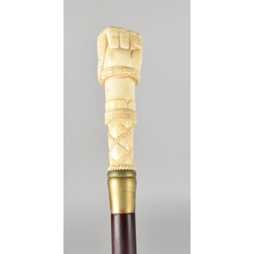 96 - A Bone Effect Handled Walking Stick in the Form of a Clenched Fist Holding Serpent, 97.5cms Long