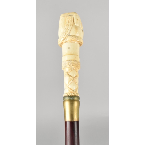 96 - A Bone Effect Handled Walking Stick in the Form of a Clenched Fist Holding Serpent, 97.5cms Long