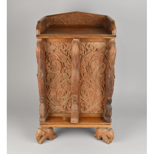 122 - A Far Eastern Carved Wooden Smokers Compendium Cabinet with Galleried Back, Hinged Doors Opening to ... 