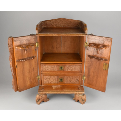 122 - A Far Eastern Carved Wooden Smokers Compendium Cabinet with Galleried Back, Hinged Doors Opening to ... 