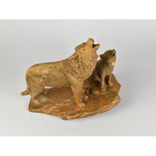 169 - A Bronzed Resin Group, Wolves on Rock, 24cms High