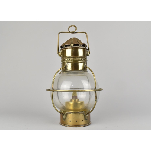 45 - A Vintage Brass and Glass 'Onion' Oil Lamp with Loop Handle, 25cms High