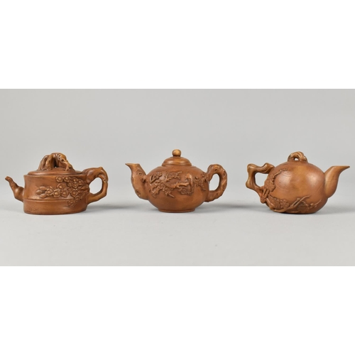 54 - Three Reproduction Carved Chinese Miniature Teapots