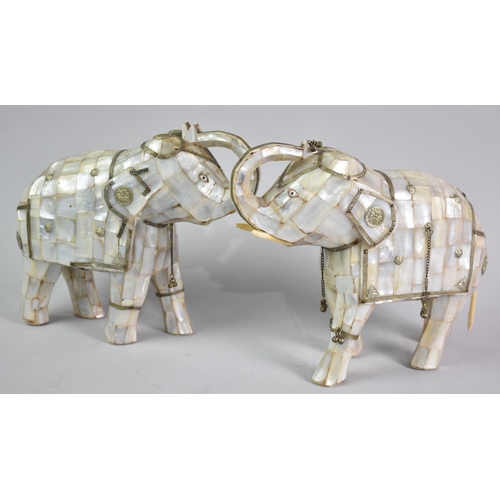 39 - A Pair of Indian Mother of Pearl Elephants with Trunks in Salute and White Metal Mounts, 22cms Long