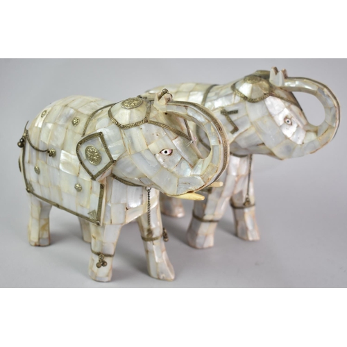 39 - A Pair of Indian Mother of Pearl Elephants with Trunks in Salute and White Metal Mounts, 22cms Long