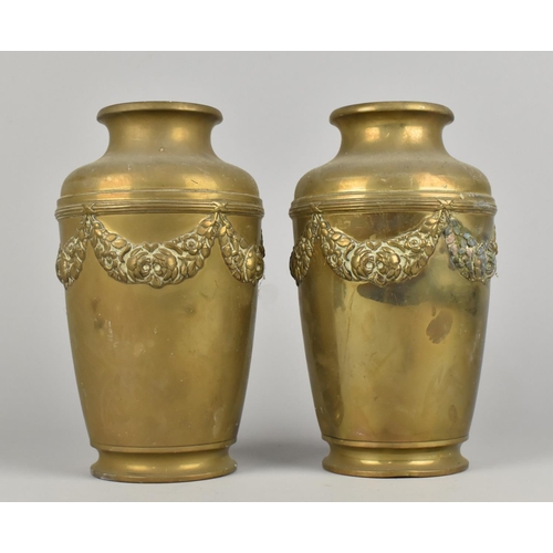 68 - A Pair of Brass Vases with Relief Floral Swag Decoration, 22cms High