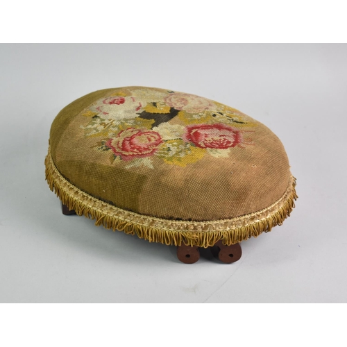 7 - A Late Victorian Oval Tapestry Upholstered Footstool with Scrolled Feet, 34cms Wide