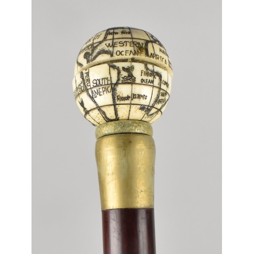 65 - A Reproduction Walking Stick with Faux Bone Finial in the Form of a Globe with Hinged Top To Sundial... 