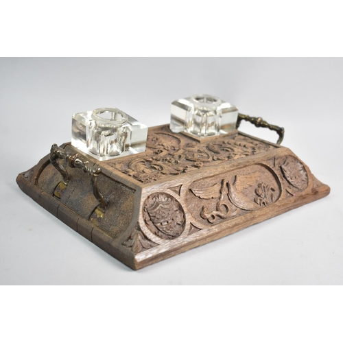 10 - An Edwardian Carved Oak Desktop Inkstand with Two Carrying handles and Two Glass Inkwells, Both Miss... 