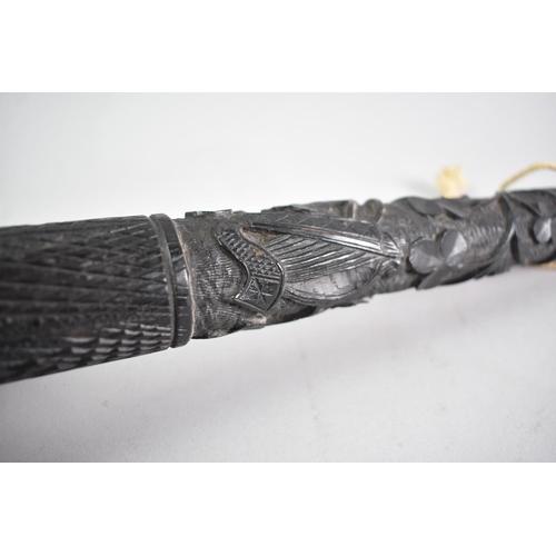 18 - An Irish Carved Bog Oak Truncheon Decorated with Shamrock and irish Harp, 36cms Long