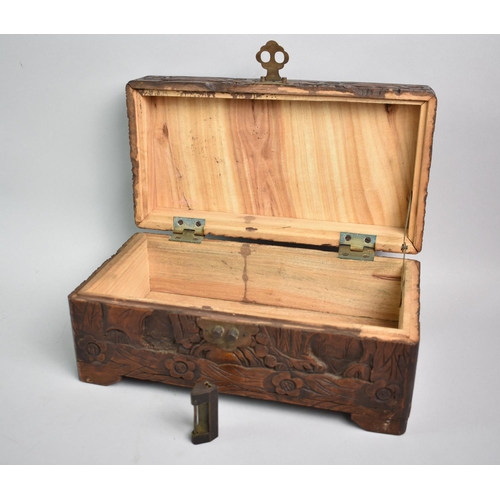 30 - An Oriental Camphor Wood Work Box with Carved Decoration to All Sides, 30cms Wide