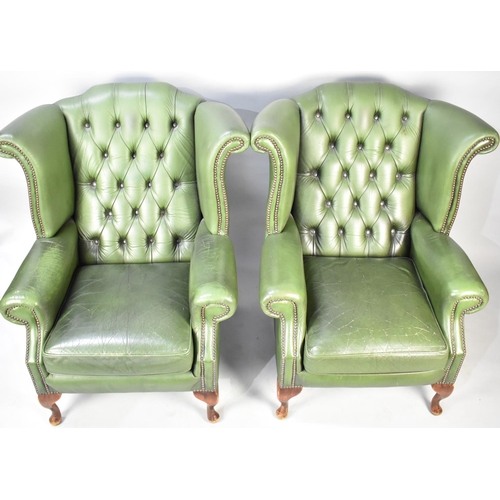 436 - A Pair of Green Leather Button Upholstered Wing Armchairs