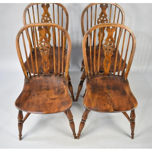 446 - A Set of Four Elm Seated Wheel Back Kitchen Chairs with Crinoline Stretchers