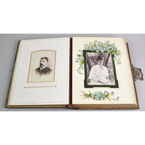 77 - A Late Victorian Photograph Album Containing Monochrome Family Portrait Photographs, Sprung Metal Cl... 