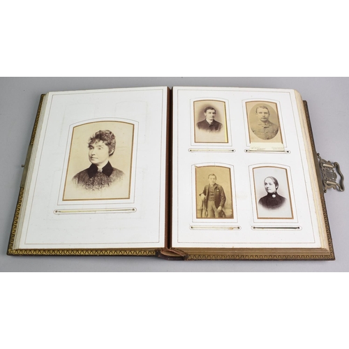 77 - A Late Victorian Photograph Album Containing Monochrome Family Portrait Photographs, Sprung Metal Cl... 