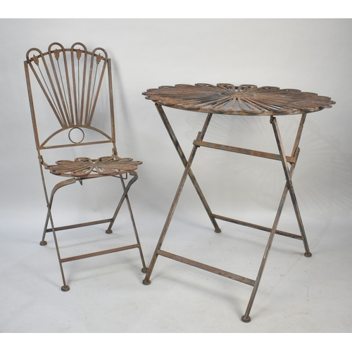 548 - A Wrought Metal Patio Table and Chair with Floral Motif