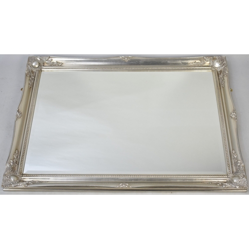 568 - A Modern Silvered Framed Rectangular Wall Mirror, 106cms by 76cms