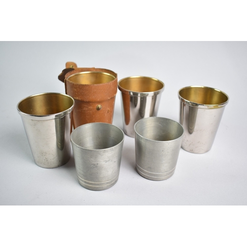 84 - A Leather Cased Set of Four Silver Plated Stacking Cups together with Two Mackinlay Pewter Examples