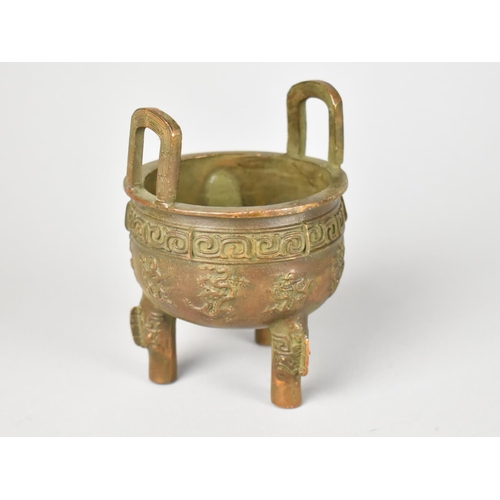 29 - A Reproduction Chinese Bronze Censer with Relief Decoration having Lug Handles and Raised on Tripod ... 