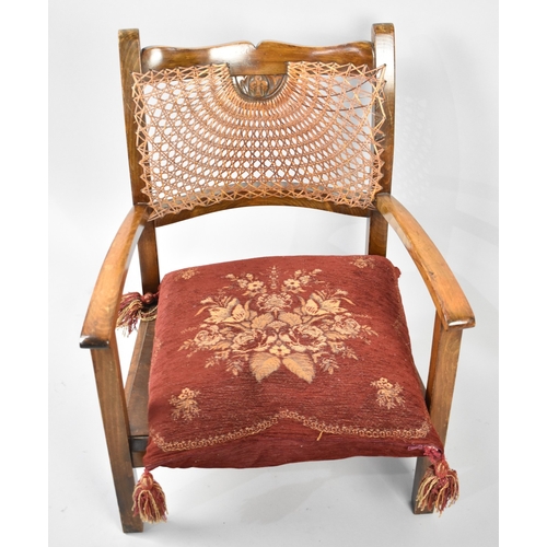 104 - A 1950s Cane Backed Nursing Arm Chair with Red Scatter Cushion