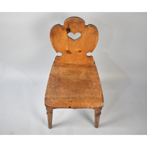 529 - A Late 19th/Early 20th Century Hall Chair with Heart Motif Cut Shield Shaped Back, 84cm high