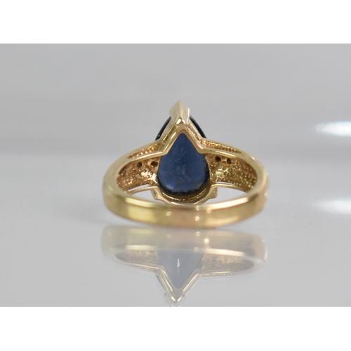 27 - A Modern Diamond and Pear Cut Blue Stone Dress Ring, Central Stone Measuring 13.1mm by 9.1mm, Suppor... 