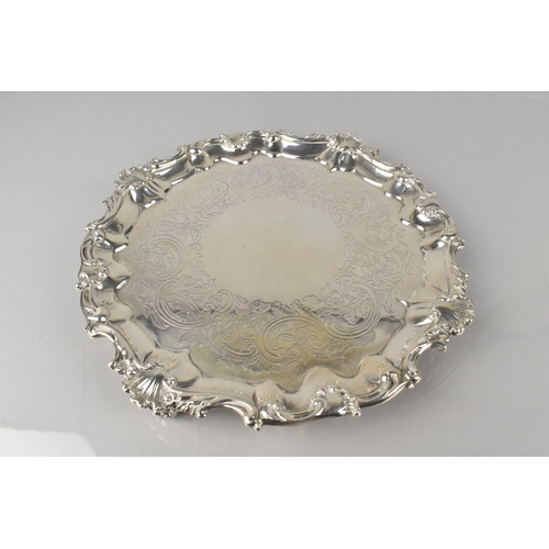 191 - A Victorian Silver Salver by Smith, Nicholson & Co., with Scrolled Shell Relief Trim and Raised on C... 