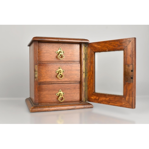 92 - An Early 20th Century Oak Table Top Collectors Chest with Front Glass Inset Door Opening to Three Dr... 