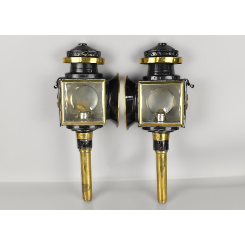 162 - A Pair of Late Victorian/Edwardian Brass and Black Lacquer Trap Lamps, 51cm high