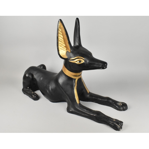 107 - A Large Cast Study of Anubis Modelled as Recumbent Jackal, Reputed to be Movie Prop, 79x53cm high