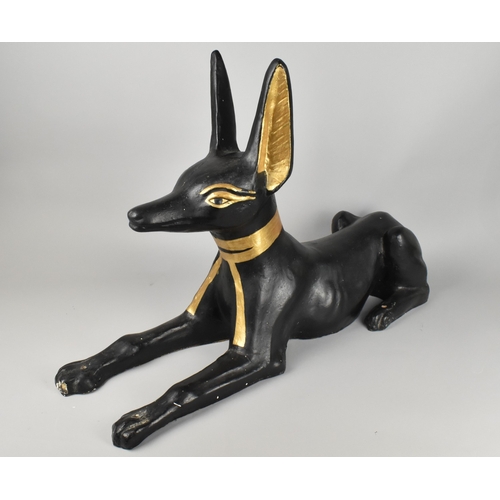 107 - A Large Cast Study of Anubis Modelled as Recumbent Jackal, Reputed to be Movie Prop, 79x53cm high