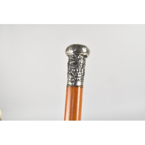 139 - A 19th Century Chinese Malacca Walking Cane with an Unmarked Silver Top Moulded with Chinese Figures... 