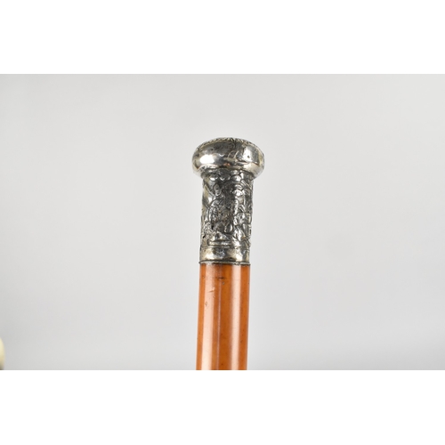 139 - A 19th Century Chinese Malacca Walking Cane with an Unmarked Silver Top Moulded with Chinese Figures... 