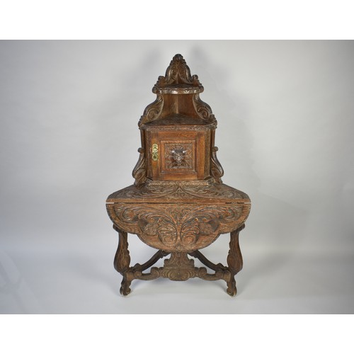 101 - A Late 19th Century Carved Oak Corner Table with Single Front Drop Leaf Raised Cupboard with Mask Ca... 