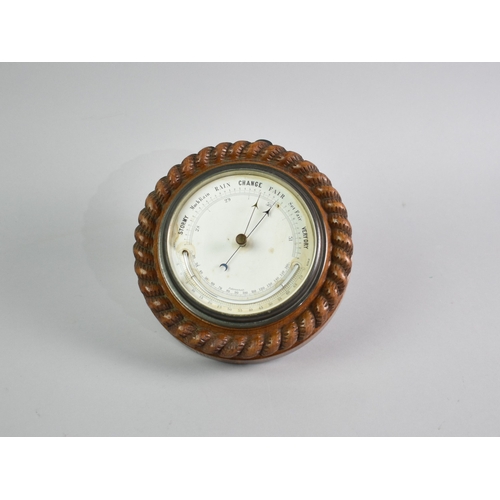 64 - An Edwardian Circular Oak Framed Aneroid Barometer with Carved Rope Border, 19cms Diameter