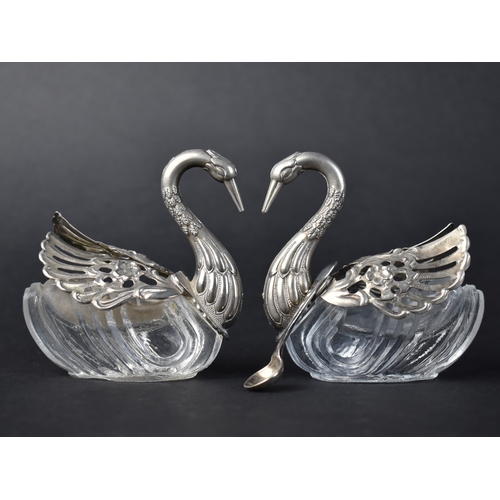 A Pair of White Metal and Glass Novelty Salts in the Form of Swans Together with a Silver Salt Spoon