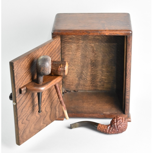 29 - An Art Deco Oak Smokers Cabinet with Three Vintage Pipes, 25cms High
