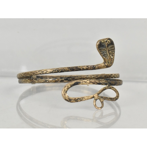 398 - An Eastern White Metal Bangle, Coiled Cobra with Engraved Scale Decoration, Internal Dimensions 7.2c... 