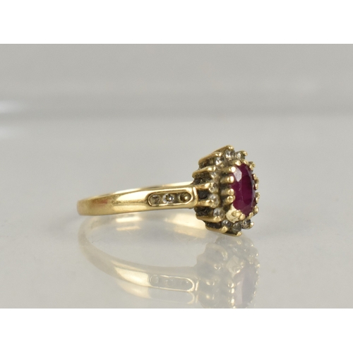 402 - A 9ct Gold, Ruby and CZ Cluster Ring, Oval Cut Ruby Approx 5.4mm by 3.9mm Supported in Fourteen Yell... 