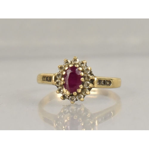 402 - A 9ct Gold, Ruby and CZ Cluster Ring, Oval Cut Ruby Approx 5.4mm by 3.9mm Supported in Fourteen Yell... 