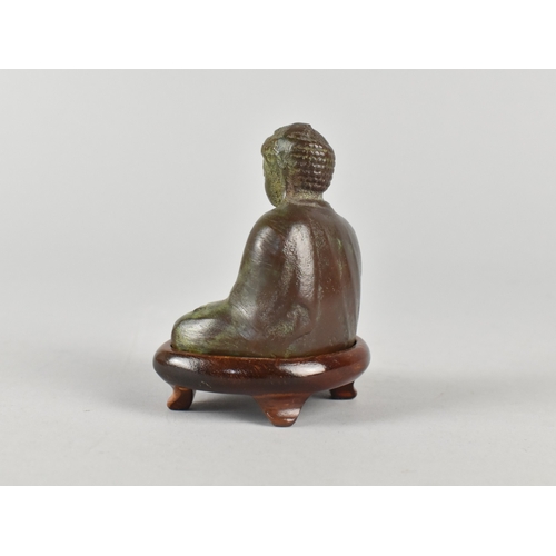 21 - A Green Patinated Bronze Miniature Buddha on Wooden Stand, Late 20th Century, 8cms High
