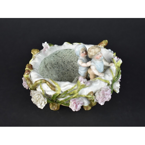 29 - A Continental Novelty Bowl in the Form of Two Children in Nest with Floral Bocage Decoration, Possib... 