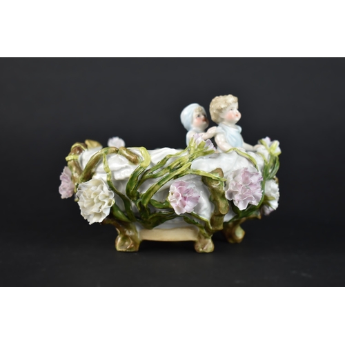 29 - A Continental Novelty Bowl in the Form of Two Children in Nest with Floral Bocage Decoration, Possib... 