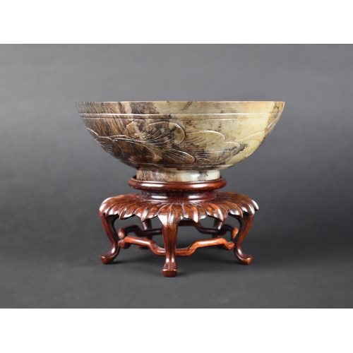 55 - A Chinese Hardstone Bowl on Carved Wooden Stand, 17cms Diameter