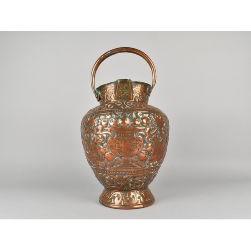 55 - An Early Copper Double Spouted Ewer/Water Bucket with Ornate Repousse Decoration Depicting Griffins,... 