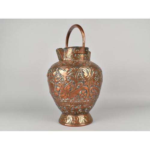 55 - An Early Copper Double Spouted Ewer/Water Bucket with Ornate Repousse Decoration Depicting Griffins,... 