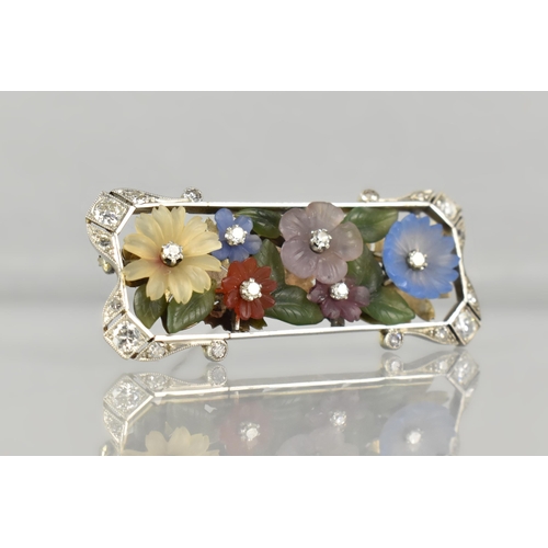 An Early 20th Century Austrian 18ct Gold, Diamond and Hardstone Mounted Floral Brooch Attributed Ernst Paltscho, Each Carved Chalcedony 'Wildflower' having Central Single Cut Diamond Raised in Six Claws, Largest Flower 11.5m Diameter, Supported on a Bed of Nephrite Jade Leaves, Rectangular White Metal Mount With Scrolled Corners having Mixed Cut Diamond Embellishments, (Largest Four Approx 2.7mm Diameter) Grain Set within Milgrain Frame and Verso with Scrolling Decoration, Stamped to Bar BS 750, 12.3gms, 49mm Wide and 19.6mm High Max, One or Two Losses to Petals, Possibly Carving Loss