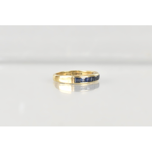 16 - A Sapphire Mounted 9ct Gold Half Eternity Ring, Channel Set Square Cut Stones in a Rectangular Reces... 